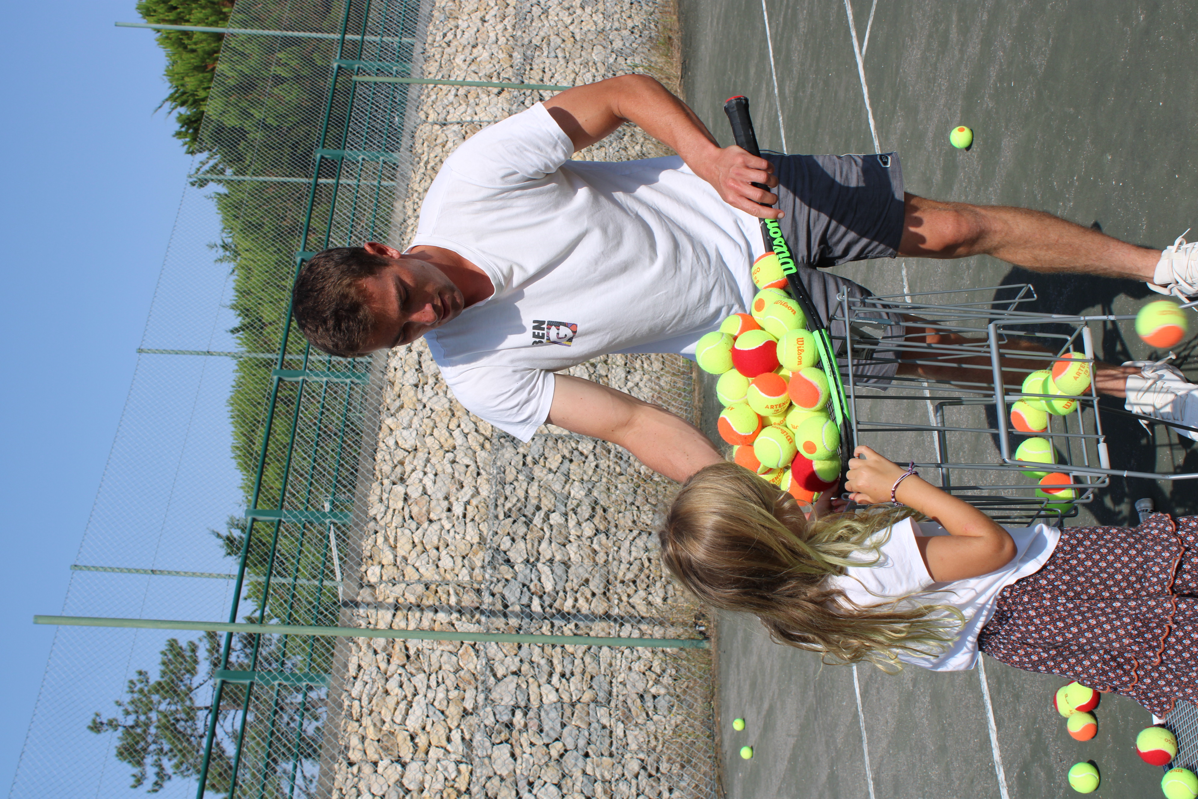 Matisse and a child having fun with tennis balls